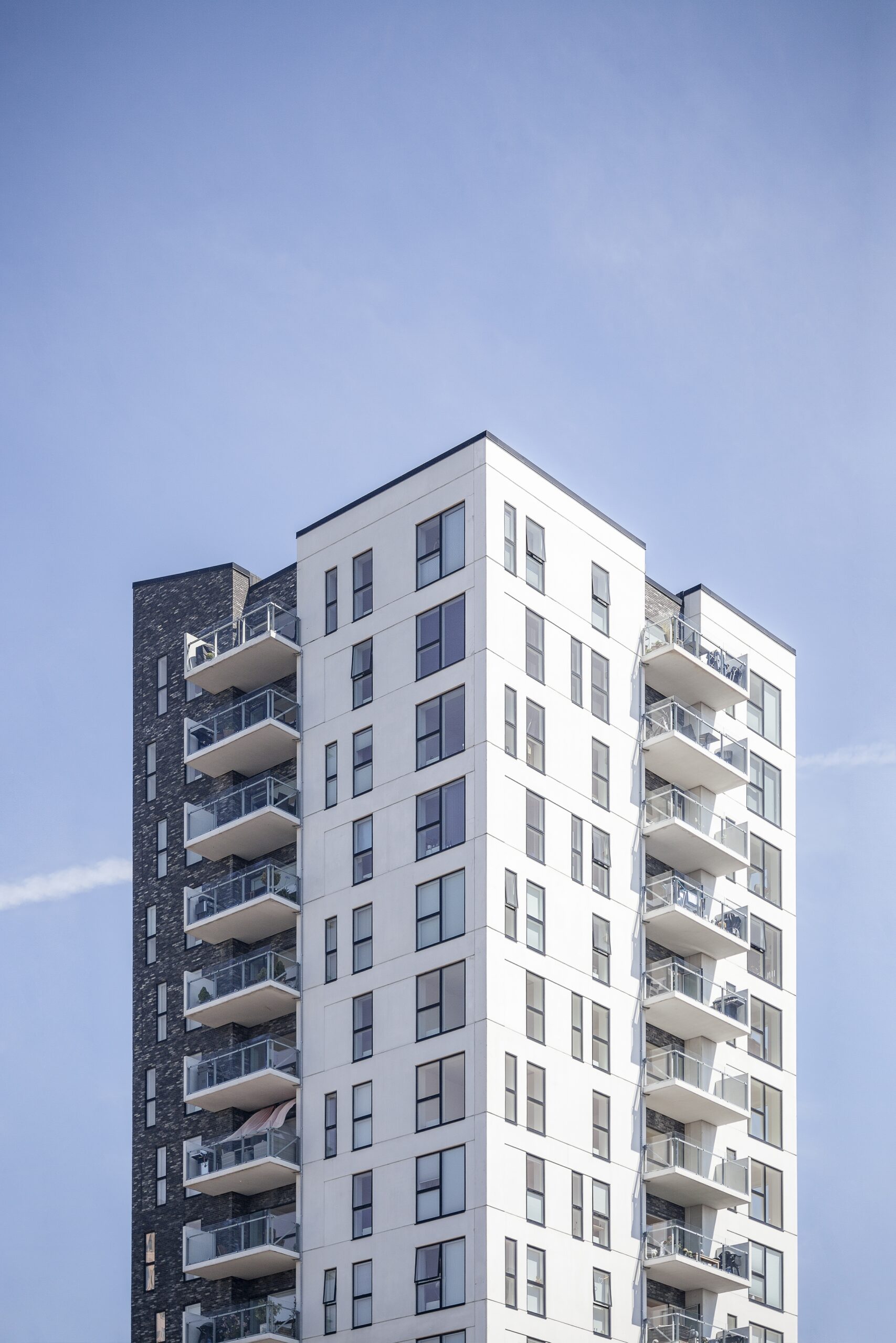 A vertical shot of a white building under the clear sky