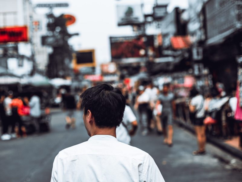 Back view of Portrait Young asian man walking on khaosan road, bangkok