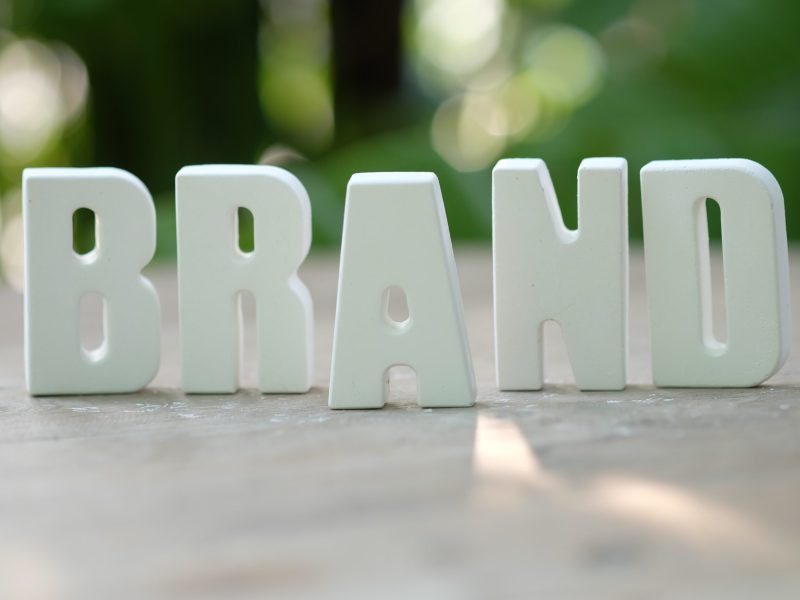Hand arrange white letters BRAND